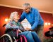 Senior couple in love, senior man take care of his wife in wheelchair